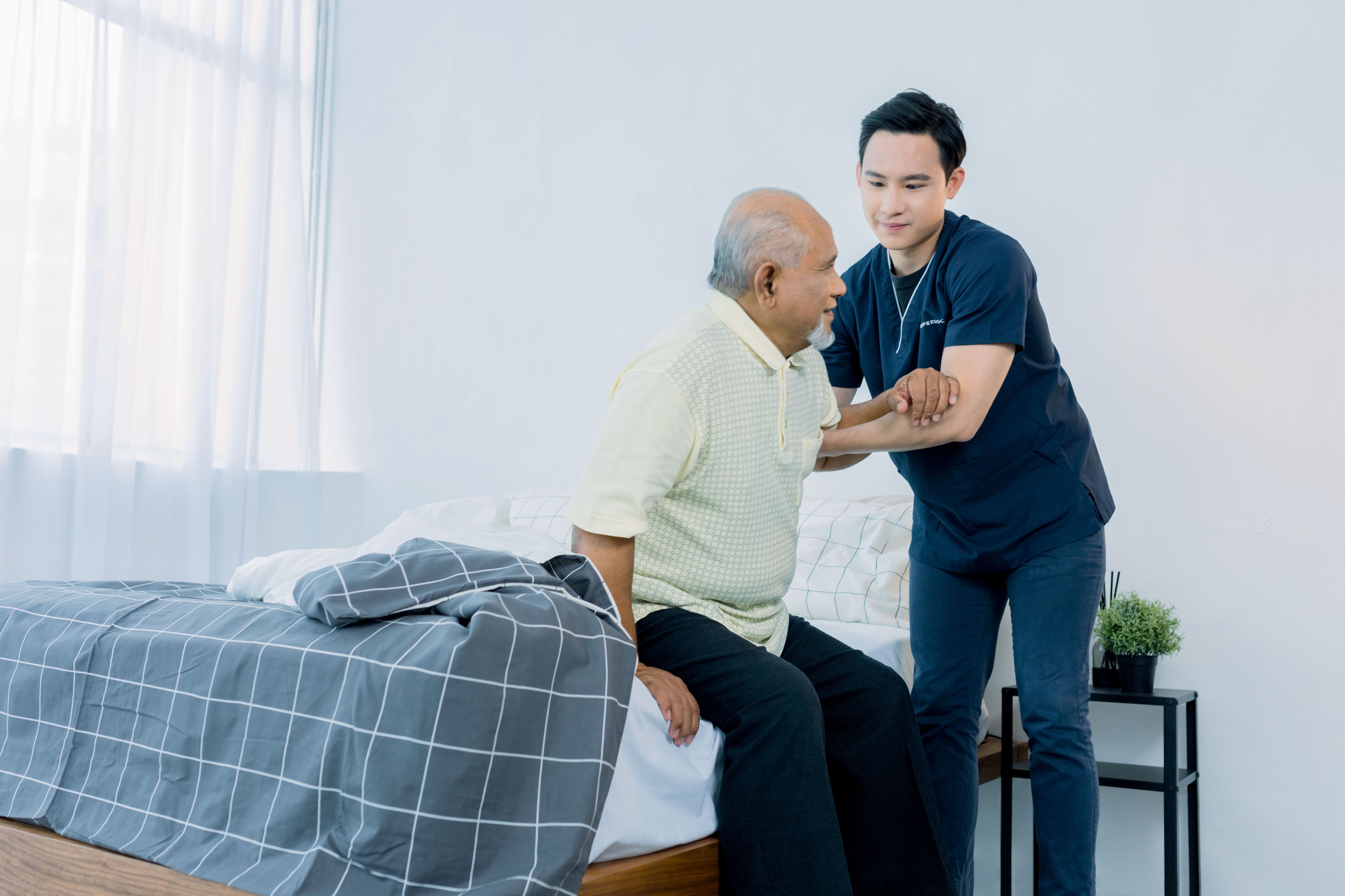 nurse helping grandpa from bed