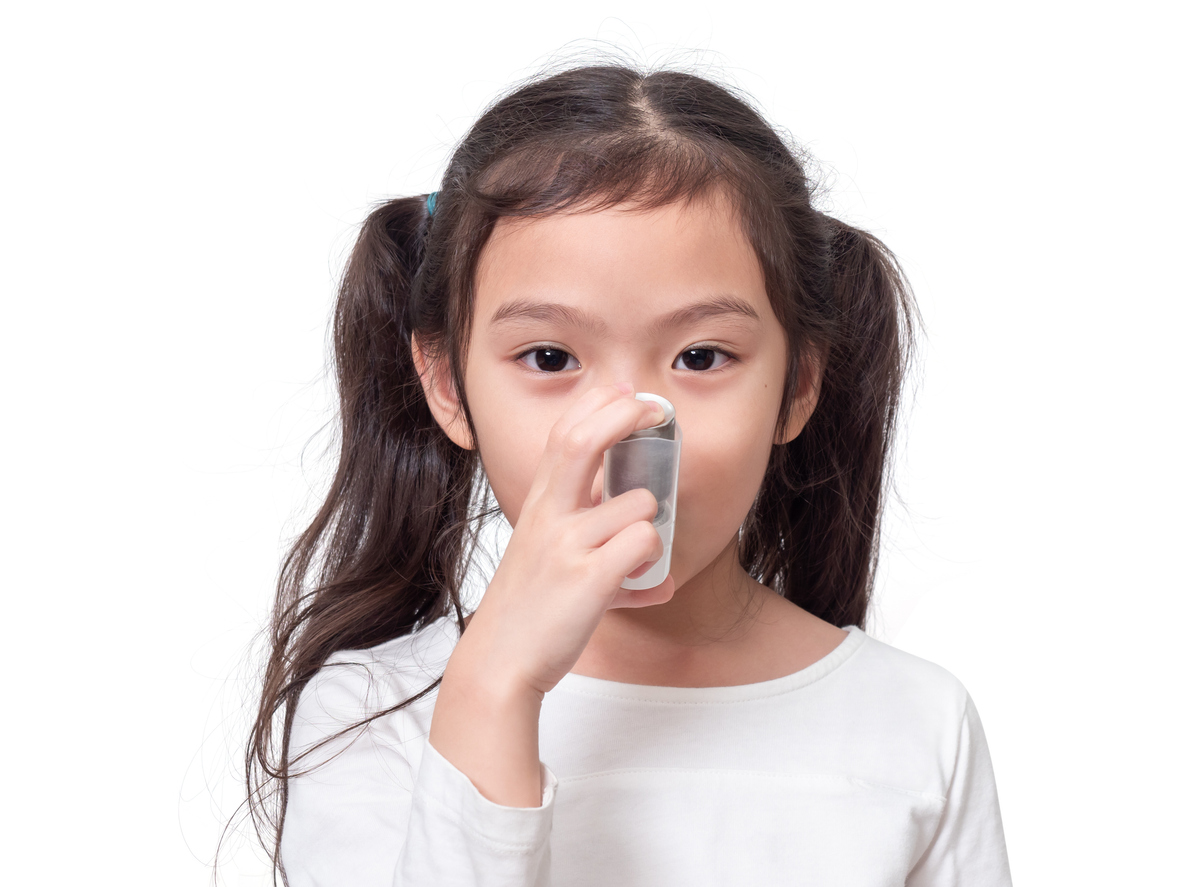 Kid using asthma inhaler